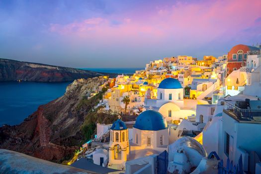 Oia town cityscape at Santorini island in Greece at sunset. Aegean sea