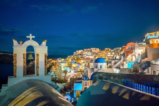 Oia town cityscape at Santorini island in Greece at sunset. Aegean sea