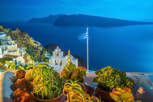 Oia town cityscape at Santorini island in Greece at sunset. Aegean sea