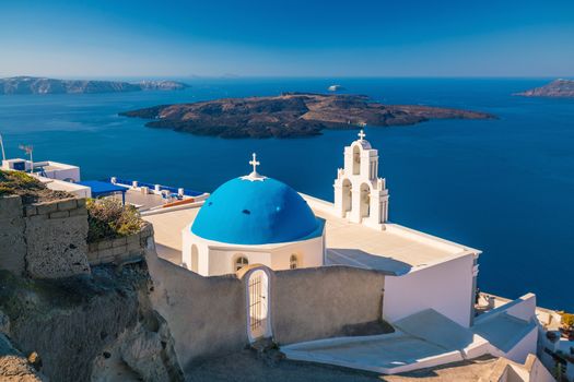 Three Bells of Fira in Santorini, Greece with blue sky