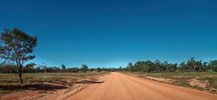 An unsealed dirt and dusty road in the Australian outback