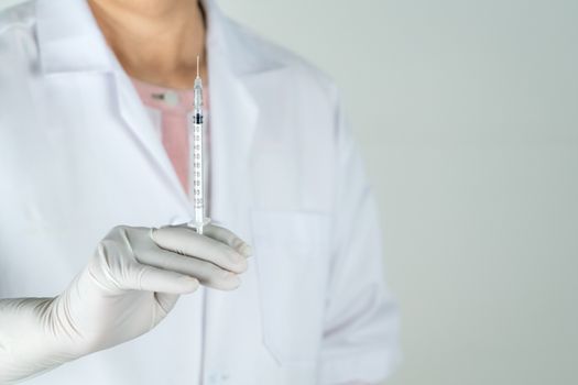 senior doctor or physician hold syringe in the hospital. Concept Of Medical Technology and Healthcare Business