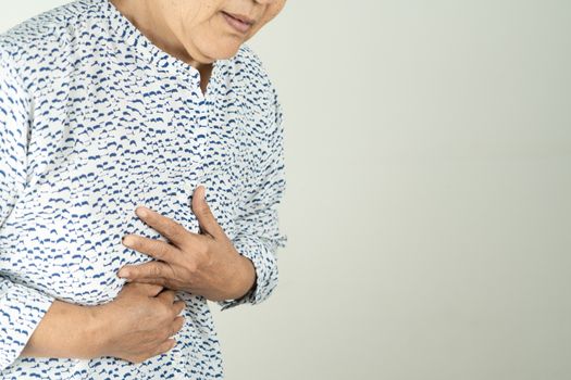 Senior woman Suffering From Acid Reflux Or Heartburn-Isolated On White Background
