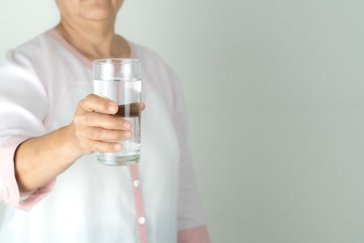 drinking water in the senior woman's hand, Concept of environment protection, healthy drink.