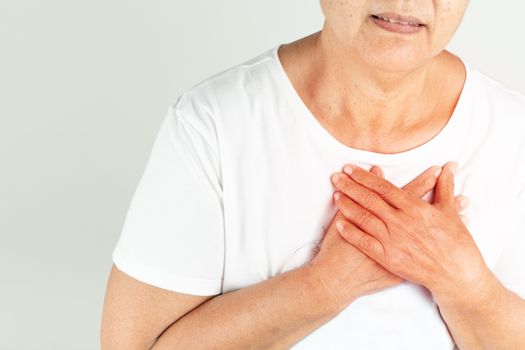 Old woman heart attack holding breast on white background