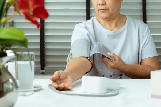 senior woman is detecting blood pressure at home