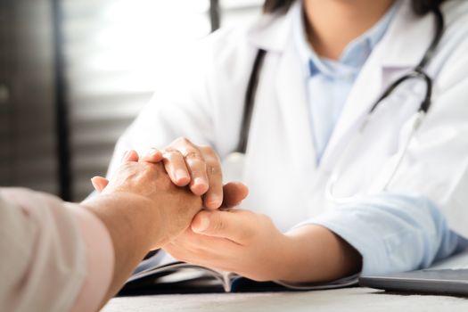 Doctor hands together holding senior woman patient