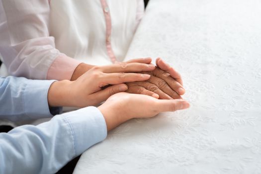 daughter encourage mom, young aged people holding old woman hand, mother day concept