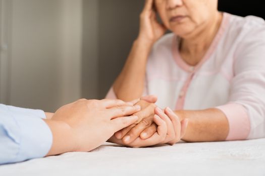 Doctor hands together holding senior woman patient