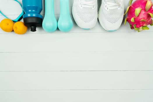 Healthy lifestyle, food and sport concept. athlete's equipment and fresh fruit on wooden background.