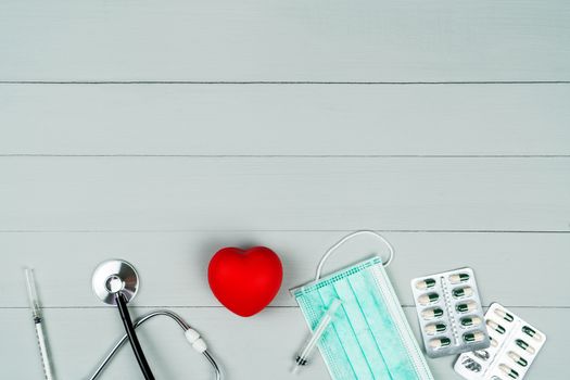 World health day concept and Healthcare medical insurance with red heart and medical instrument on wooden background