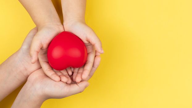 world health day, adult and child hands holding red heart, healthcare, love and family insurance concept