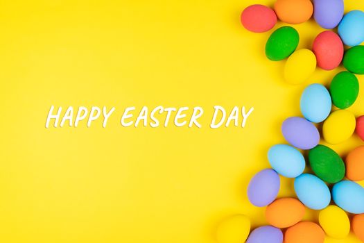 Easter day with decorated eggs on yellow background