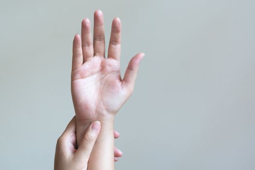 Woman massaging her painful hand. Healthcare and medical concept.