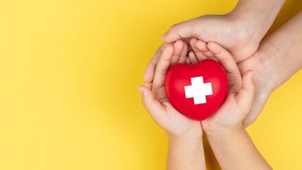 world red cross day, adult and child hands holding red heart, healthcare, love and family insurance concept