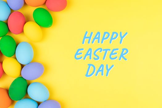 Easter day with decorated eggs on yellow background