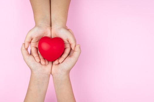 world health day, adult and child hands holding red heart, healthcare, love and family insurance concept