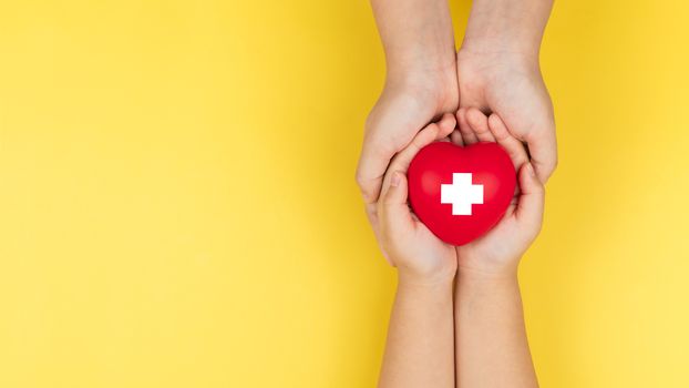 world red cross day, adult and child hands holding red heart, healthcare, love and family insurance concept