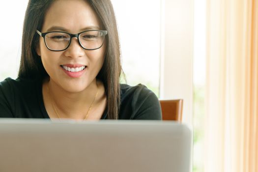 working from home during Coronavirus or Covid-19 outbreak, young woman smiling while conference with team