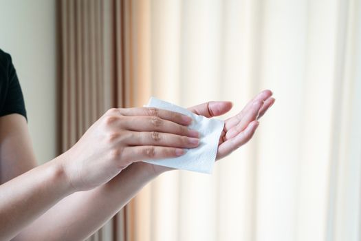 Woman cleaning her hands with white soft tissue paper. isolated on a white backgrounds