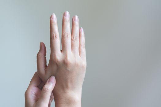 Woman massaging her painful hand. Healthcare and medical concept.