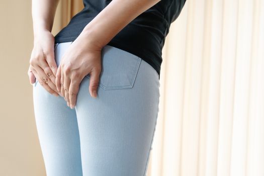 Disorder, Diarrhea, incontinence. Healthcare concept. Woman hand holding her bottom