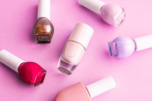 Nail polish bottles on pink background, beauty branding