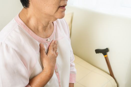 heart attack old woman holding chest in bed room, healthcare problem of senior concept