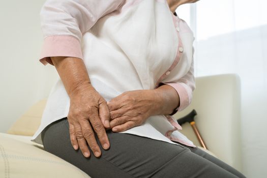 Hip pain of senior woman at home, healthcare problem of senior concept