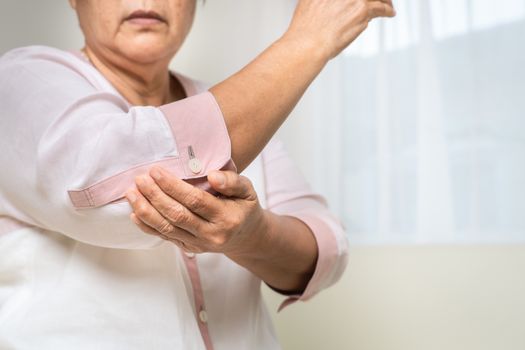 elbow pain old woman suffering from elbow pain at home, healthcare problem of senior concept