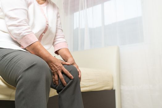 Knee pain of old woman at home, healthcare problem of senior concept