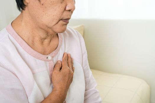 heart attack old woman holding chest in bed room, healthcare problem of senior concept