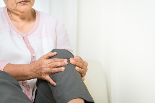Knee pain of senior woman at home, healthcare problem of senior concept
