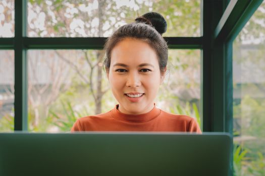 Asia woman smile and looking at laptop. Happy woman working at office
