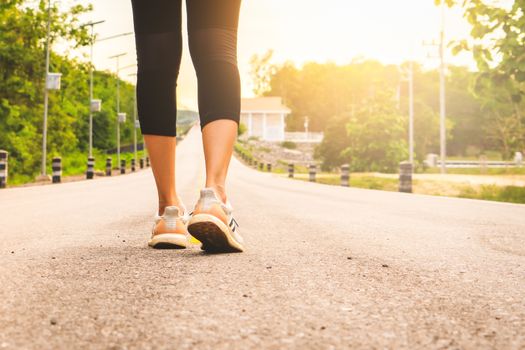 Sport female runner legs ready for run on forest trail