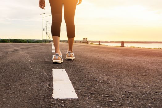 Sport female runner legs ready for run on forest trail