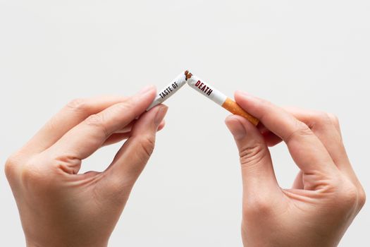 Quit smoking, no tobacco day, woman hands breaking the cigarette