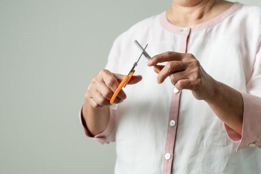 Quit smoking, no tobacco day, mother is cutting the cigarette