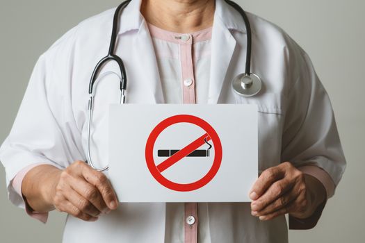 Quit smoking, no tobacco day, doctor holding no smoking sign