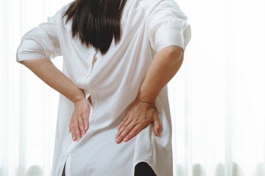 back pain at home. women suffer from backache. healthcare and medical concept