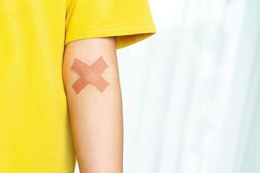 woman arm with a croos plaster. Blood donation concept