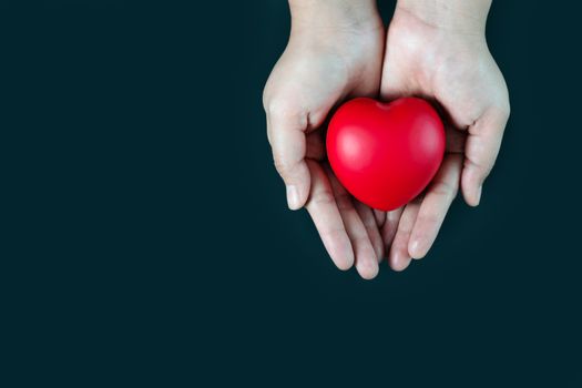 woman holding red heart on hand, Blood donation concept