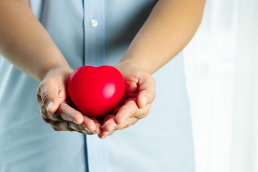 woman holding red heart on hand, Blood donation concept