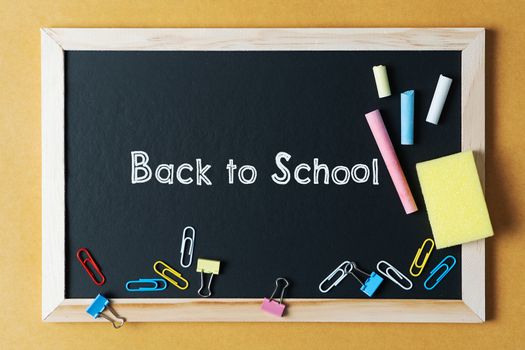 School supplies on black board background. Back to school concept