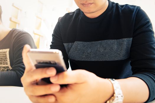 New messages on smartphone, man  looking at mobile phone checking email or message