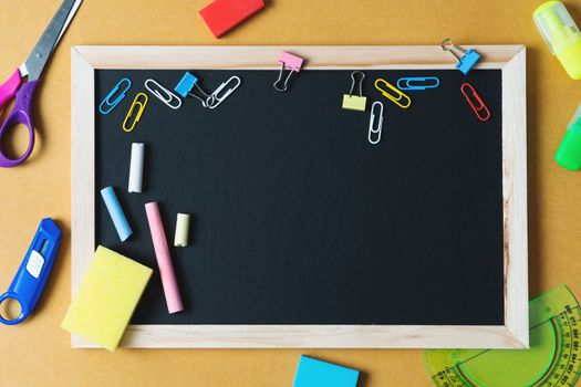 School supplies on black board background. Back to school concept