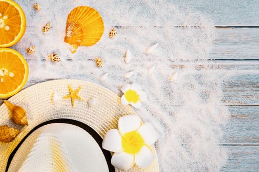 Beautiful summer holiday, Beach accessories, sunglasses, hat, oranges and shells on wooden backgrounds