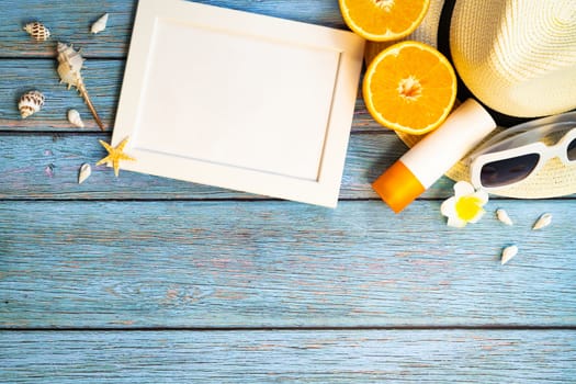 Beautiful summer holiday, Beach accessories, orange, sunglasses, hat and sunblock on wooden backgrounds