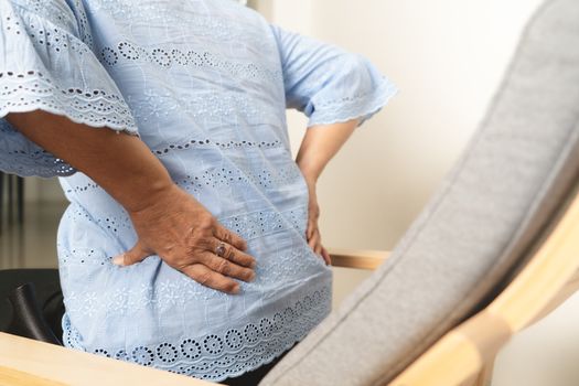 Old woman back pain at home, health problem concept