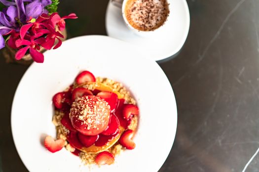 freshly homemade Pancakes Strawberry Crumble on white dessert plate